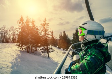 Little skier on the ski lift