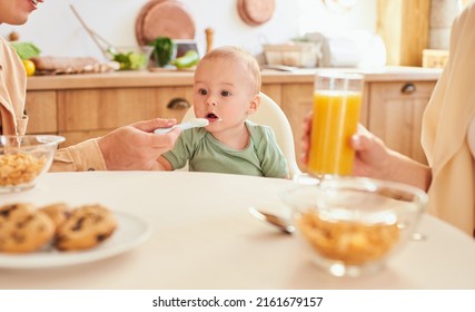 Little Small Caucasian Toddler Infant New Born Baby Eating Yogurt While Dad Father Feeding Child Kid. Young Family Of Three Having Morning Breakfast At Home Kitchen.