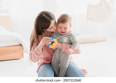 Little small crying shouting baby child kid infant toddler newborn feeling hungry, needs to change diapers, suffering from colics and teething. Motherhood and childcare
