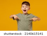 Little small smiling happy boy 6-7 years old in green casual t-shirt point in index finger on himself isolated on plain yellow background studio portrait. Mother