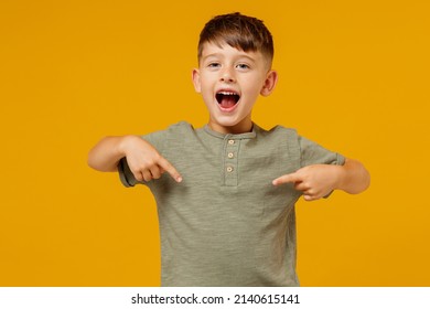 Little small smiling happy boy 6-7 years old in green casual t-shirt point in index finger on himself isolated on plain yellow background studio portrait. Mother's Day love family lifestyle concept