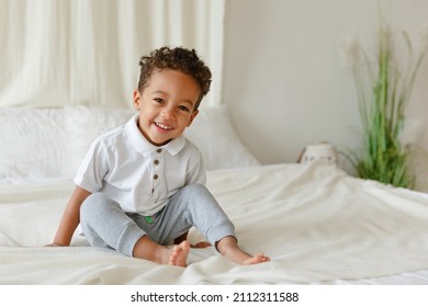 Little smiling boy. playing African American toddler. Positive kid. Cute baby. The concept of a happy childhood and child care. - Shutterstock ID 2112311588