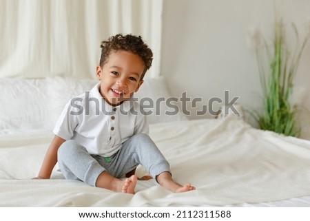Little smiling boy. playing African American toddler. Positive kid. Cute baby. The concept of a happy childhood and child care.