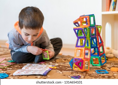 Little Smiling Boy Playing With Magnetic Constructor Toy. Boy Playing Intellectual Toys