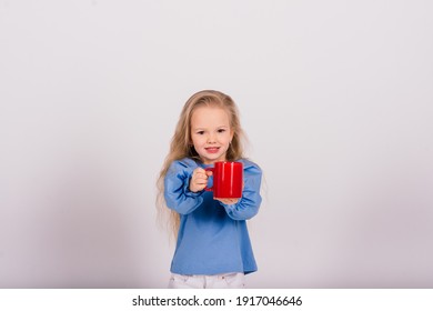 Little Smiling Child Girl Holding Cup, Isolated Over White Background. Studio Shooting