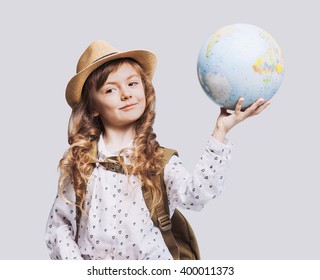 Little smiling girl holding globe, travel concept - Powered by Shutterstock