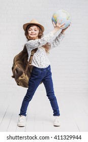 Little Smiling Girl Holding Globe, Travel Concept