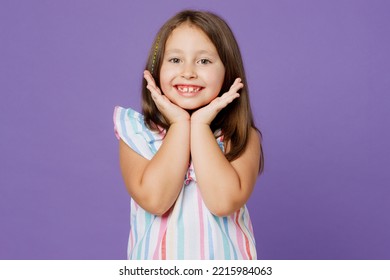 Little smiling nice cheerful happy european fun kid child girl 6-7 years old wears striped dress hold face isolated on plain pastel light purple background. Mother's Day love family lifestyle concept - Shutterstock ID 2215984063