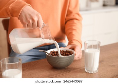 Little son eating cornflakes with milk on breakfast in kitchen, closeup - Powered by Shutterstock