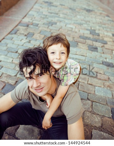 little son with father in city