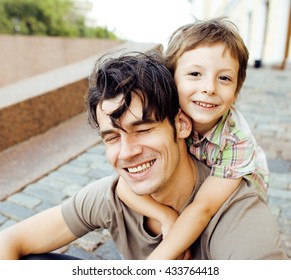 little son with father in city hagging and smiling, casual look outside playing, happy real family, lifestyle people concept - Shutterstock ID 433764418