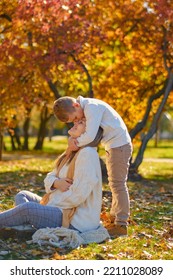 Little Son Hugs His Pregnant Mom On The Nature. Boy And Smiling Pregnant Woman Sitting In Autumn Park. Young Happy Family Waiting Baby. Pregnant Woman Enjoying Time With Her Child