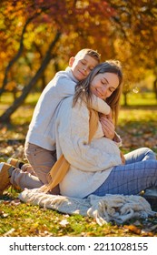 Little Son Hugs His Pregnant Mom On The Nature. Boy And Smiling Pregnant Woman Sitting In Autumn Park. Young Happy Family Waiting Baby. Pregnant Woman Enjoying Time With Her Child