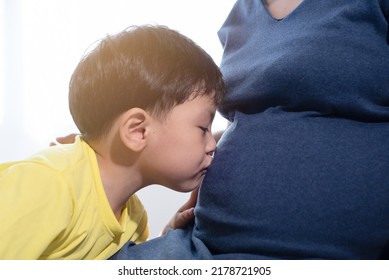 Little Son Kissing On Pregnant Mom Tummy With Love, So Much Care On Mom Health, Expected To See A New Born Very Soon