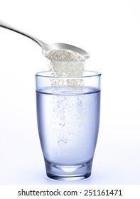 Little Spoon Pouring Powder On Water Glass