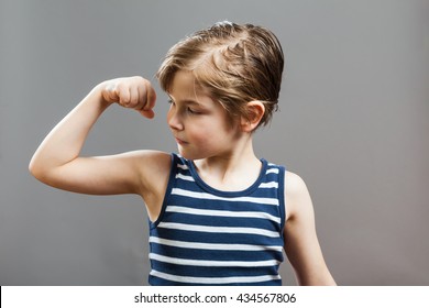 Little Sportive Tough Boy In Striped  Muscle Shirt, Looking At His Muscles