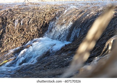 Little spring waterfall in the fields