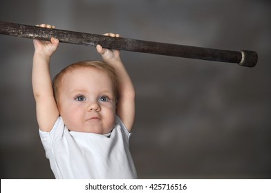 Little Strong Baby Toddler Playing Sports. Kid During His Workout. Success And Winner Concept