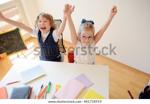 Little Students Doing Exercises While Sitting Stock Photo Edit