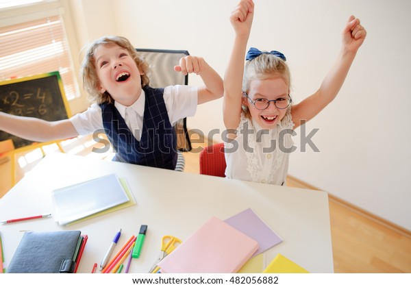 Little Students Doing Exercises While Sitting Stock Photo Edit