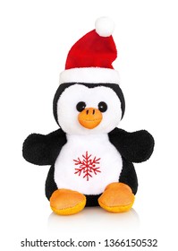 Little stuffed penguin toy with christmas cap. Isolated on white background with shadow reflection. With clipping path. Fatso on white. Cute fatty puppy stuffie plaything.