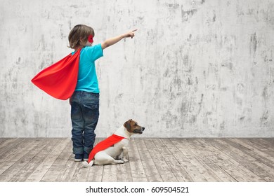 Little superhero with dog in studio
