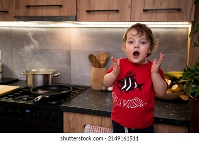 Little Suprised Kid In The Kitchen. Words Printed On The T-shirt 