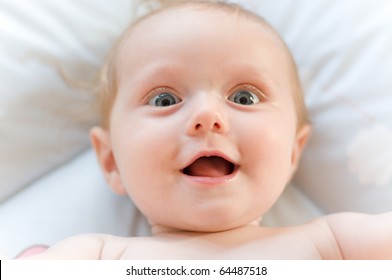 Little Sweet Baby Laughing With Big Eyes And Open Mouth