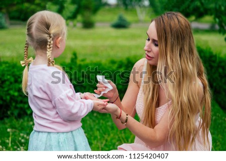 Little And Sweet Blonde Girl In A Cute Gray Dress Together With Toothy Smile Beautiful Mother Little And Sweet Blonde Girl In A Cute Gray Dress Together With Toothy Smile Beautiful Mother