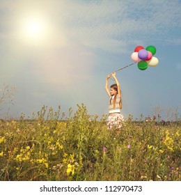 Little teenager child girl with balloons in summer day