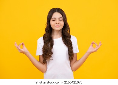 Little Teenager Kid Girl 12-14 Years Old In White Shirt Hold Hands In Yoga Om Aum Gesture Relax Meditate Try Calm, Isolated On Yellow Background.