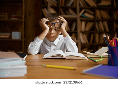 Little tired boy schoolchild falling asleep while doing homework - Powered by Shutterstock