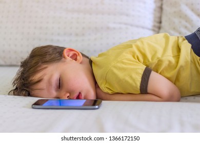 Little Tired Sleeping Child Boy Hand Holding Digital Smartphone. Portrait Of Cute Sleeping Boy. Sweet Dreams. Boy Sleeping While Lying On Couch At Home