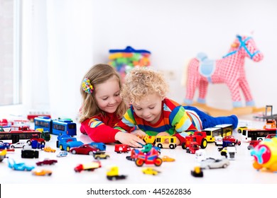 Little Toddler Boy And Girl Playing With Model Car Collection On The Floor. Transportation And Rescue Toys For Children. Toy Mess In Child Room. Many Cars For Little Boys. Educational Games For Kids.