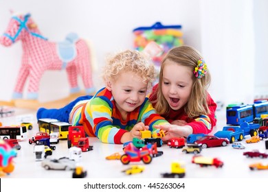 Little Toddler Boy And Girl Playing With Model Car Collection On The Floor. Transportation And Rescue Toys For Children. Toy Mess In Child Room. Many Cars For Little Boys. Educational Games For Kids.