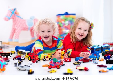 Little Toddler Boy And Girl Playing With Model Car Collection On The Floor. Transportation And Rescue Toys For Children. Toy Mess In Child Room. Many Cars For Little Boys. Educational Games For Kids.