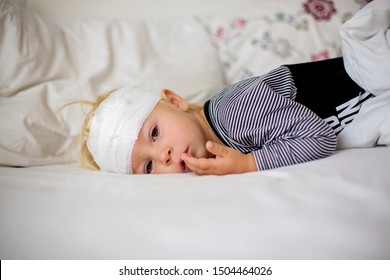 Little Toddler Boy With Head Injury, Lying In Bed, Tired, Sleeping