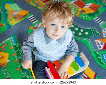 Little Toddler Boy Playing With Wooden Music Toy Indoor