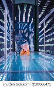 Little Toddler Boy In A Space Ship, Illuminated In Different Colors, Staying On Bridge