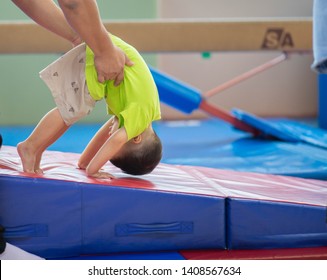 Little toddler boy working out at the indoor gym excercise