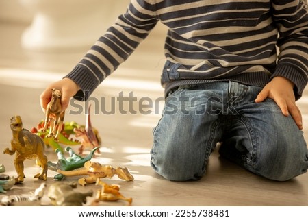 Little toddler child, boy,  pee in his pants while playing with toys, child distracted and forget to go to the toilet at home