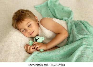 Little Toddler Child, Cute Kid With Knitted Small Cute Animal Toy, Lying In Bed, Cuddling