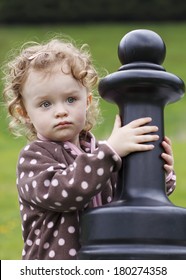 Little Toddler Playing Chess Outside