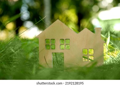 Little Toy Model House In Large Grass Meadow Field.