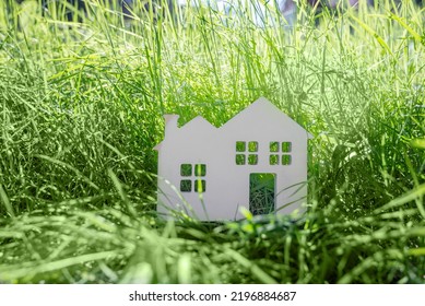 Little Toy Model House In Large Grass Meadow Field.