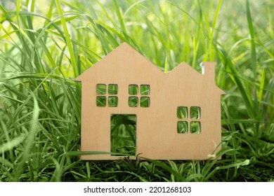 Little Toy Model House In Large Grass Meadow Field.