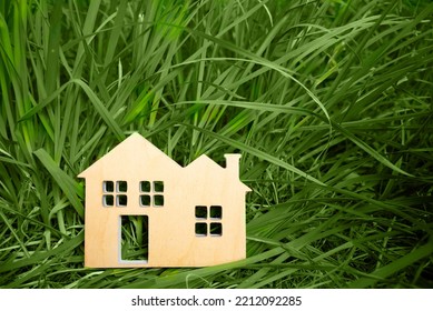 Little Toy Model House In Large Grass Meadow Field.