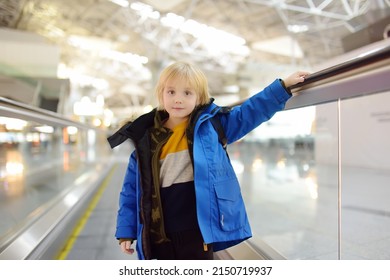 Little Traveler On A High-speed Sidewalk At An International Airport. Family Trip For Winter Holidays. Kids Vacations. Relocation To Another Country