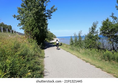 Little Traverse Wheelway is a picturesque paved trail running parallel to the Route 31. The 26-mile path stretches from Charlevoix to Petoskey to Harbor Springs, in Northern Michigan. - Shutterstock ID 2191321445