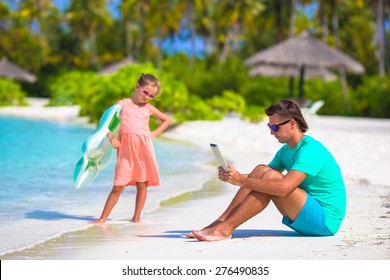Little upset sad girl waiting father to swim while he working